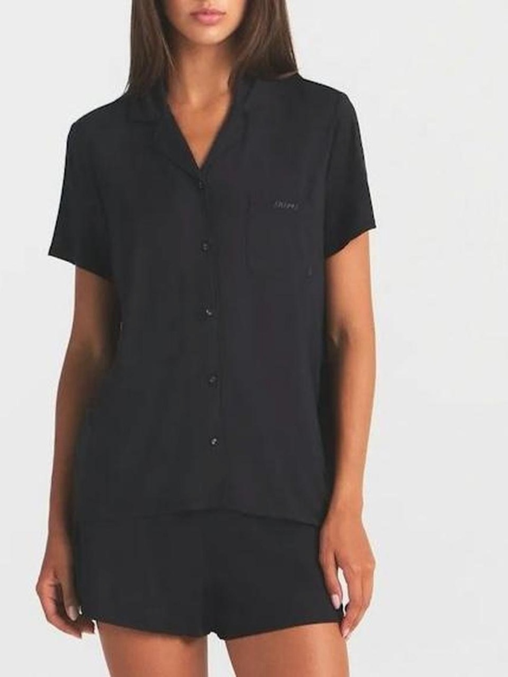 SKIMS Sleep Pajama Set includes Short Sleeves Button-Up Top and Matching Shorts.